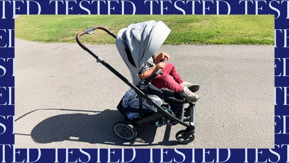 Adding a weighted bag to a stroller to test its frame stability.