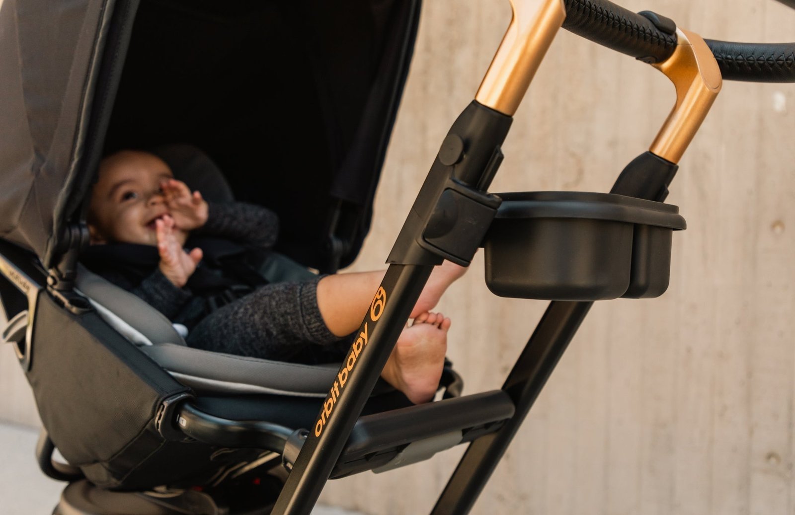 A modern full-size stroller parked in a sunlit living room.