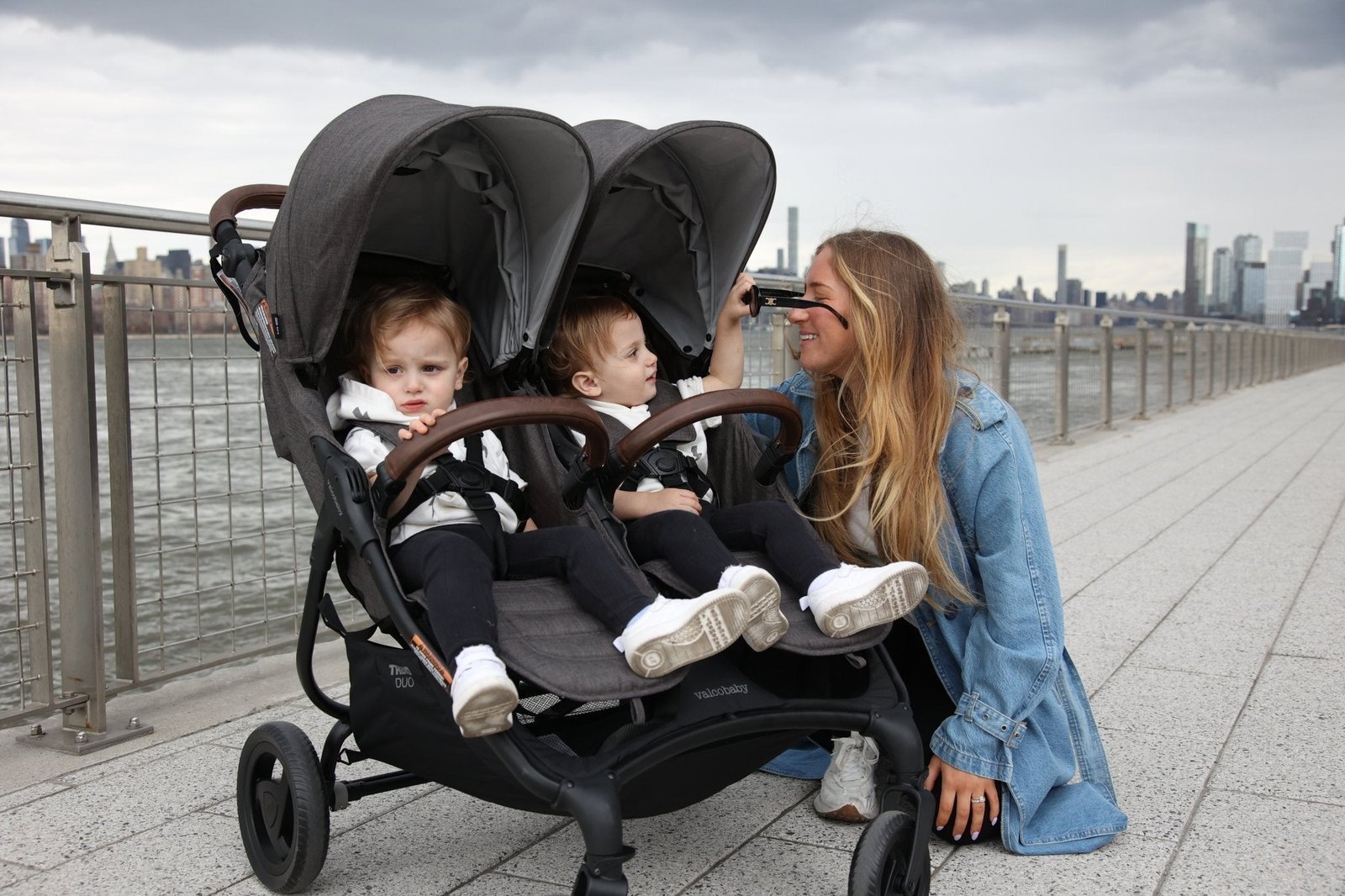 A close-up of a safety label on a stroller leg confirms construction standards.