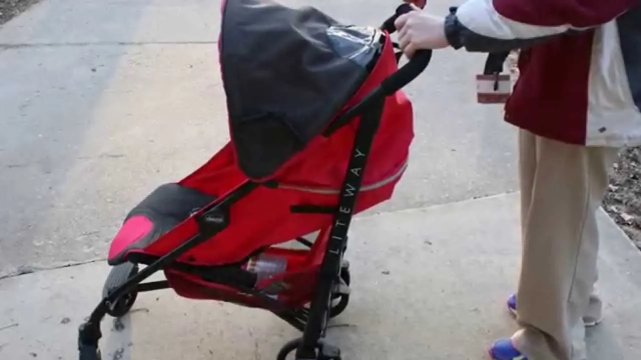 Chicco stroller mid-fold beside a folded one on wooden floor