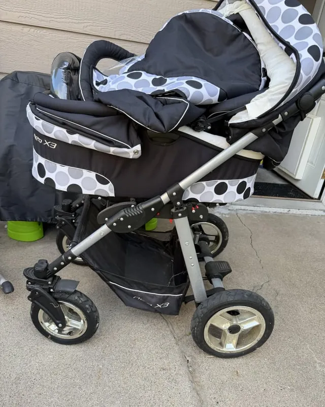 Person cleaning a stroller with soapy water before donation