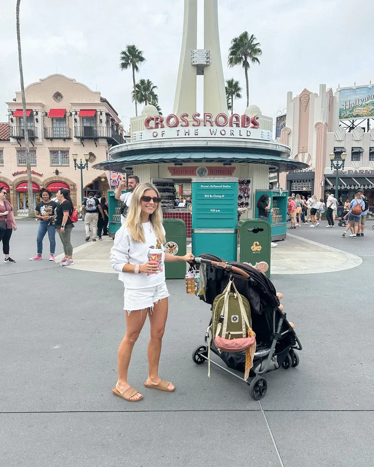 Stroller parking area near Disney World ride entrance during busy afternoon